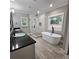 Modern bathroom featuring a soaking tub, glass-enclosed shower, and dual sink vanity at 6093 Wayfarer Dr, Villa Rica, GA 30180