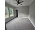 Bedroom featuring plush carpet, natural light from windows, and neutral color palette at 6093 Wayfarer Dr, Villa Rica, GA 30180