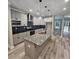 Well-lit kitchen featuring granite countertops, stainless steel appliances, and an island with pendant lights at 6093 Wayfarer Dr, Villa Rica, GA 30180