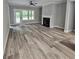 Bright living room with wood-look flooring, a fireplace, and a ceiling fan at 6093 Wayfarer Dr, Villa Rica, GA 30180