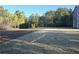 Large backyard with partially sodded lawn and wooded area at 85 Heyman Dr, Covington, GA 30016