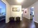 Bright hallway with dark hardwood floors and access to bedrooms at 965 Mulberry Bay Dr, Dacula, GA 30019