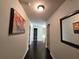 Second floor hallway with dark hardwood floors and artwork at 965 Mulberry Bay Dr, Dacula, GA 30019