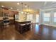 Open kitchen with island, stainless steel appliances, and hardwood floors at 965 Mulberry Bay Dr, Dacula, GA 30019