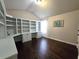 Home office with built-in shelving and hardwood floors at 965 Mulberry Bay Dr, Dacula, GA 30019