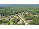 Aerial view of a residential neighborhood, surrounded by verdant green forests and picturesque landscapes at 3215 Kylee Dawn Cir, Lawrenceville, GA 30045