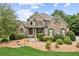 Charming home exterior boasts stone accents, mature landscaping, and a welcoming front porch at 3215 Kylee Dawn Cir, Lawrenceville, GA 30045