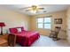 Bedroom with a double bed, rocking chair, and ceiling fan at 3736 Bloxham Ct, Atlanta, GA 30341