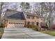 Brick house with two-car garage and landscaped yard at 3736 Bloxham Ct, Atlanta, GA 30341