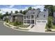 Two-story white brick house with gray roof and a front porch in a neighborhood at 3065 Barnes Mill Ct, Roswell, GA 30075