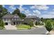 Two-story light beige brick house with a gray roof in a neighborhood at 3065 Barnes Mill Ct, Roswell, GA 30075