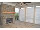 Covered patio with brick fireplace and ceiling fan at 3065 Barnes Mill Ct, Roswell, GA 30075