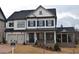 Two-story home with white siding, dark shutters, and a metal roof at 3065 Barnes Mill Ct, Roswell, GA 30075