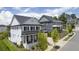 Two-story home with white brick exterior, black shutters, and a front porch at 3065 Barnes Mill Ct, Roswell, GA 30075