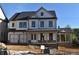 Two-story home features a front porch, gray roof, and white siding at 3065 Barnes Mill Ct, Roswell, GA 30075