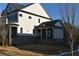 Side view of a two-story house with gray siding and a covered porch at 3065 Barnes Mill Ct, Roswell, GA 30075