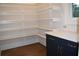 Walk-in pantry with white shelves and blue cabinets at 3065 Barnes Mill Ct, Roswell, GA 30075