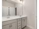 Double vanity bathroom with gray cabinets and a large mirror at 739 Marlay Sw Ln, Powder Springs, GA 30127