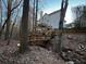 Spacious deck overlooks wooded area with steps leading to a charming bridge at 700 Somerset Vale Dr, Lawrenceville, GA 30044