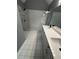 Modern bathroom with double vanity, marble shower, and white tile at 700 Somerset Vale Dr, Lawrenceville, GA 30044