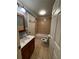 Clean bathroom with tub, toilet and wood vanity at 700 Somerset Vale Dr, Lawrenceville, GA 30044