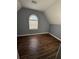 Spacious bedroom with wood-look flooring and an arched window at 700 Somerset Vale Dr, Lawrenceville, GA 30044