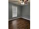 Bright bedroom with dark wood floors and white blinds at 700 Somerset Vale Dr, Lawrenceville, GA 30044