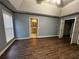 Main bedroom with dark flooring, ceiling fan and access to bathroom at 700 Somerset Vale Dr, Lawrenceville, GA 30044