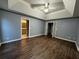 Main bedroom with dark flooring, ceiling fan and access to bathroom at 700 Somerset Vale Dr, Lawrenceville, GA 30044