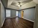 Main bedroom with dark flooring, and two windows with blinds at 700 Somerset Vale Dr, Lawrenceville, GA 30044