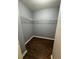 Walk-in closet with wire shelving and dark wood-look flooring at 700 Somerset Vale Dr, Lawrenceville, GA 30044