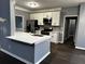 Modern kitchen with white cabinets, stainless steel appliances, and quartz countertops at 700 Somerset Vale Dr, Lawrenceville, GA 30044