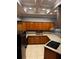 Kitchen with wood cabinets, granite counters, and tile floors at 700 Somerset Vale Dr, Lawrenceville, GA 30044