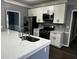 Updated kitchen featuring white shaker cabinets, stainless steel appliances, and quartz countertops at 700 Somerset Vale Dr, Lawrenceville, GA 30044