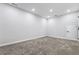 Unfinished basement with neutral carpeting and recessed lights at 1706 Pardee Dr, Kennesaw, GA 30152