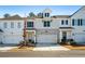 Two story townhome with white and gray siding, stone accents, and two-car garage at 1706 Pardee Dr, Kennesaw, GA 30152