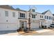 Modern two-story townhome with white and gray exterior, stone accents, and attached garage at 1706 Pardee Dr, Kennesaw, GA 30152