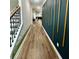 Light-filled hallway with wood-look floors, accent wall, and view to living area at 1706 Pardee Dr, Kennesaw, GA 30152