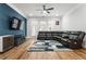 Spacious living room with dark leather sectional and blue accent wall at 1706 Pardee Dr, Kennesaw, GA 30152