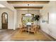 Open concept dining area with hardwood floors, a round table and chairs, and a view into the entryway at 6055 Tattnall Overlook, Acworth, GA 30101