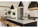 Stylish kitchen features white cabinets, dark island, and pendant lighting over the island at 6055 Tattnall Overlook, Acworth, GA 30101