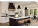 Modern kitchen with white cabinets, a large island, and a black range hood at 6055 Tattnall Overlook, Acworth, GA 30101