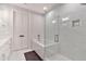Elegant bathroom featuring a glass shower, soaking tub, and marble tile at 6890 Peachtree Dunwoody Rd # 303, Atlanta, GA 30328