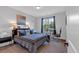 Cozy bedroom with a large window, desk, and neutral decor at 6890 Peachtree Dunwoody Rd # 303, Atlanta, GA 30328