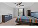 Bedroom features a ceiling fan, large window and closet at 6890 Peachtree Dunwoody Rd # 303, Atlanta, GA 30328