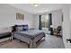 Neutral bedroom design features a queen bed with window providing natural light at 6890 Peachtree Dunwoody Rd # 303, Atlanta, GA 30328