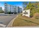Attractive apartment building exterior with well-maintained landscaping and clear signage at 6890 Peachtree Dunwoody Rd # 303, Atlanta, GA 30328