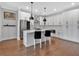 Modern kitchen with white cabinetry, stainless steel appliances, and dark pendant lighting at 6890 Peachtree Dunwoody Rd # 303, Atlanta, GA 30328