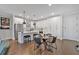 Bright open kitchen featuring white cabinets, stainless steel appliances, island, and dining table at 6890 Peachtree Dunwoody Rd # 303, Atlanta, GA 30328