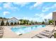 Community pool with plenty of lounge chairs and shade umbrellas at 2955 Steinbeck St, Cumming, GA 30041